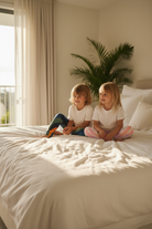 Siblings on bed